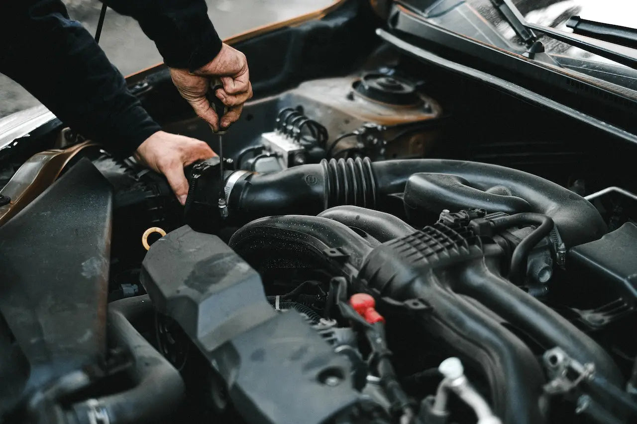 Man working on car with bonnet up