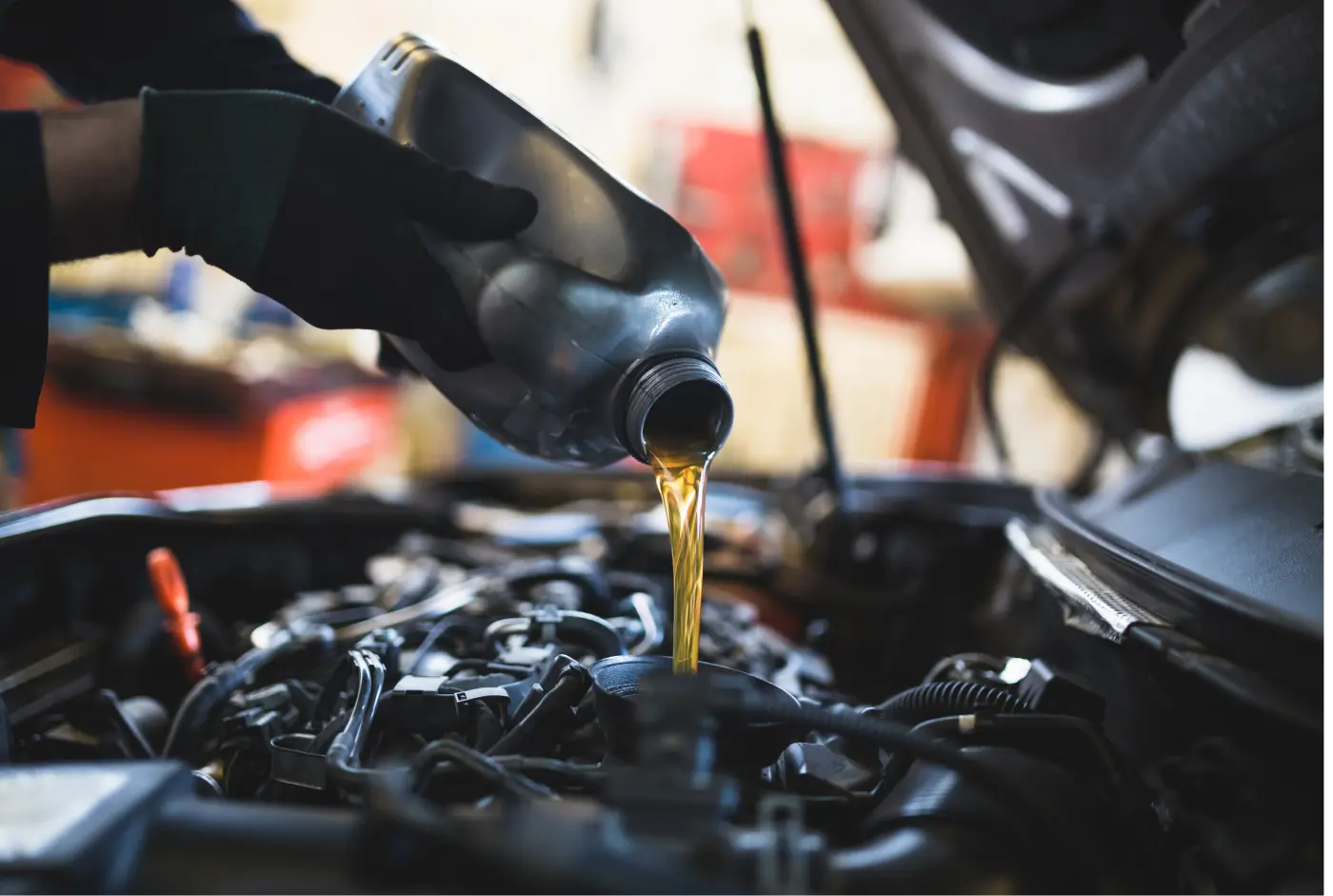 Man pouring oil into engine